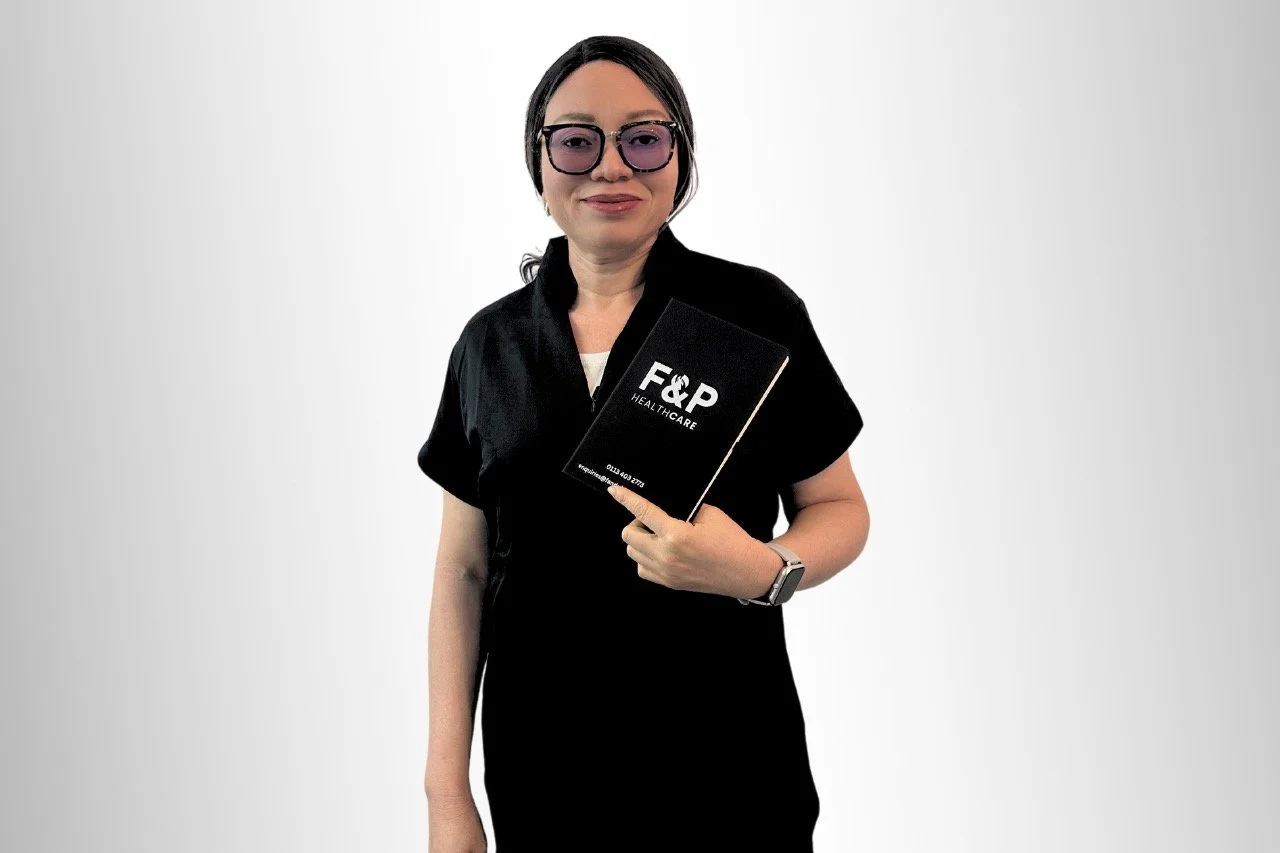 F&P Healthcare professional holding an F&P folder