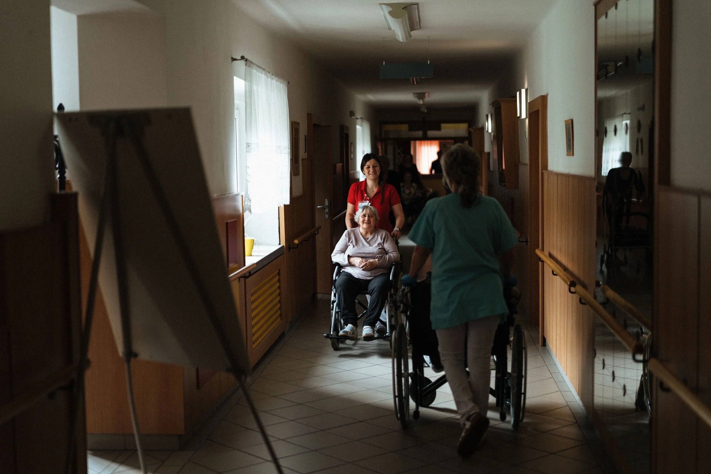 Support worker helping a wheelchair user access accessible transport