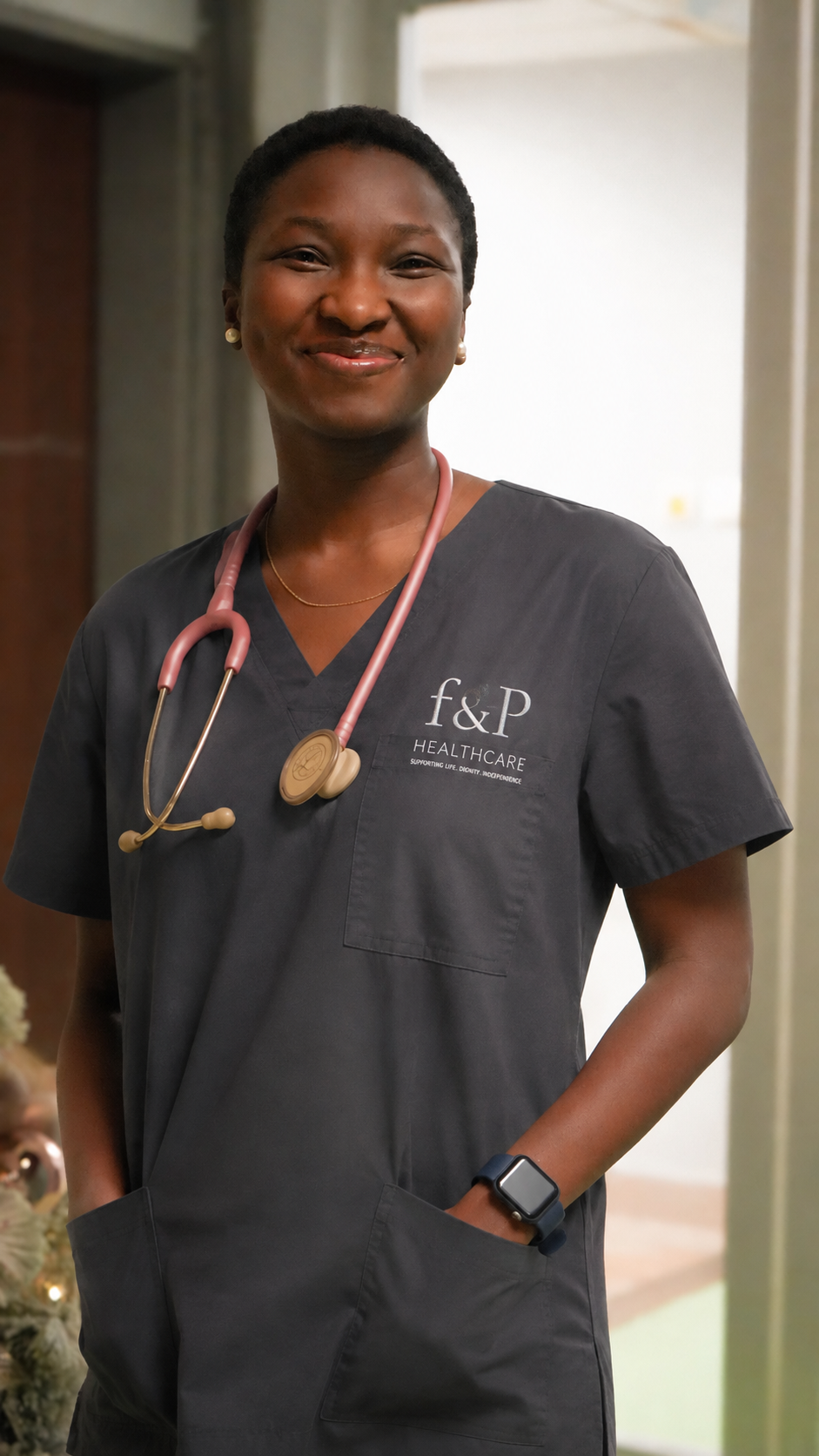 F&P Healthcare professional wearing navy scrubs and a stethoscope