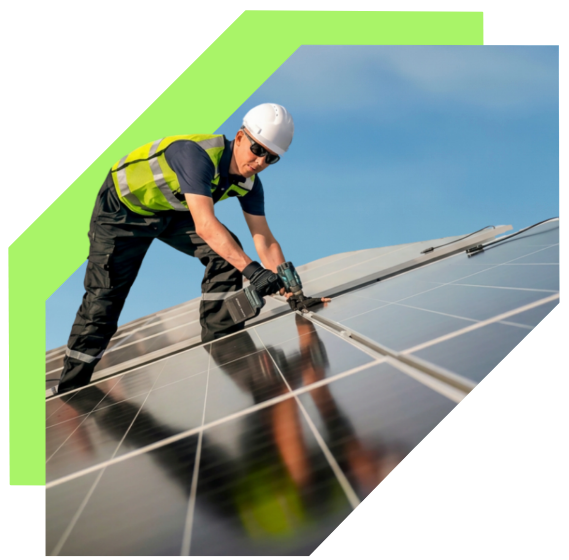 A worker in safety gear installing or maintaining solar panels on a rooftop.
