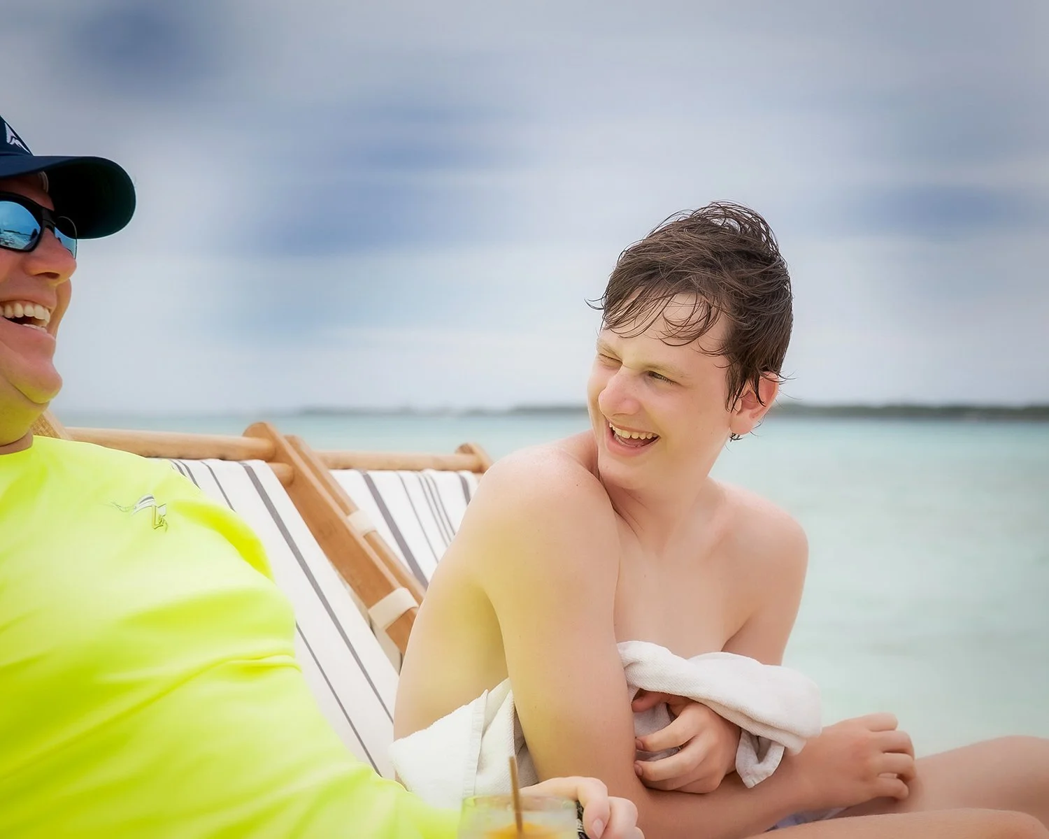 Candid Family Lifestyle Photography of a Father and Son Relaxing at a Tropical Beach Resort