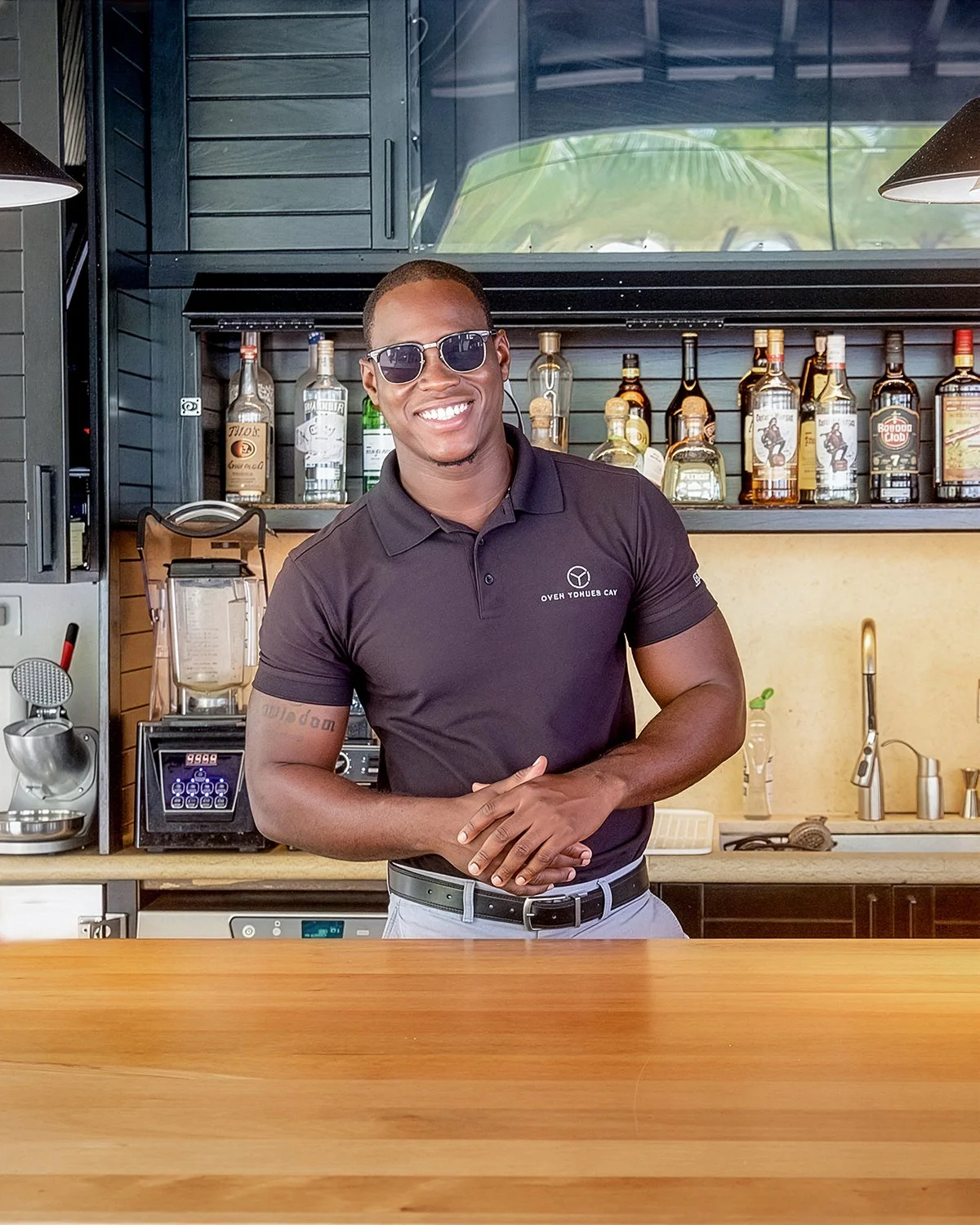 Luxury Hospitality Branding Portrait of a Resort Bartender Standing at an Outdoor Wooden Bar Counter
