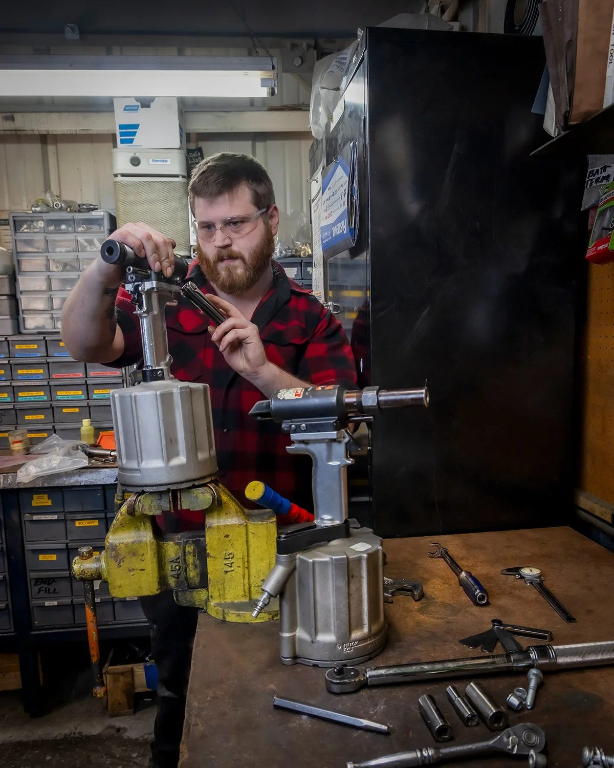 Industrial Factory Photography of a Technician Servicing Pneumatic Tools in a Workshop