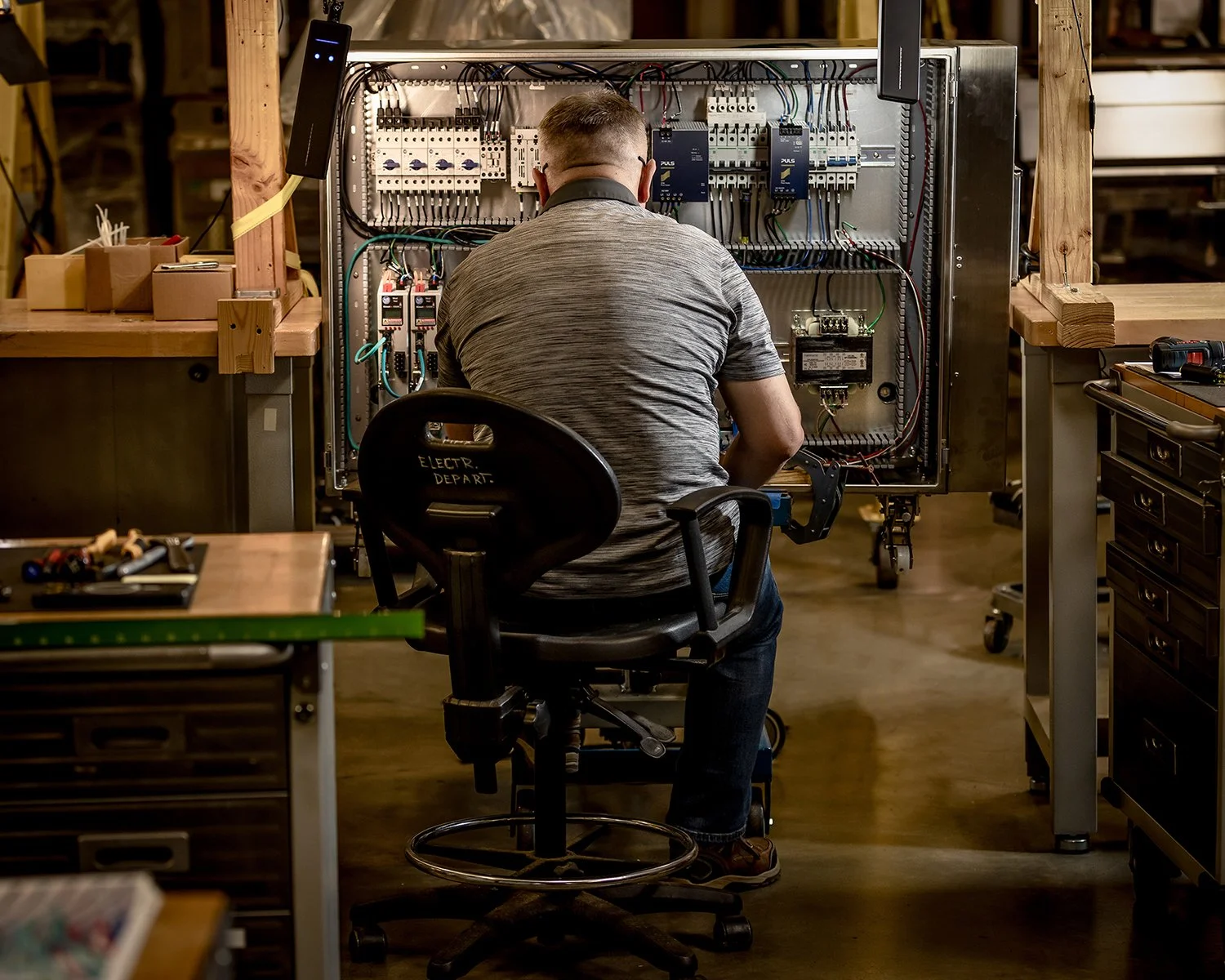 Chicago Industrial Photography of the 
Back of a Man Working on Electrical Circuit Board