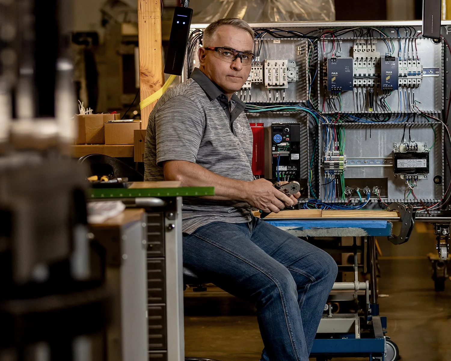 Portrait of Man in Front of Electrical Board in a Warehouse