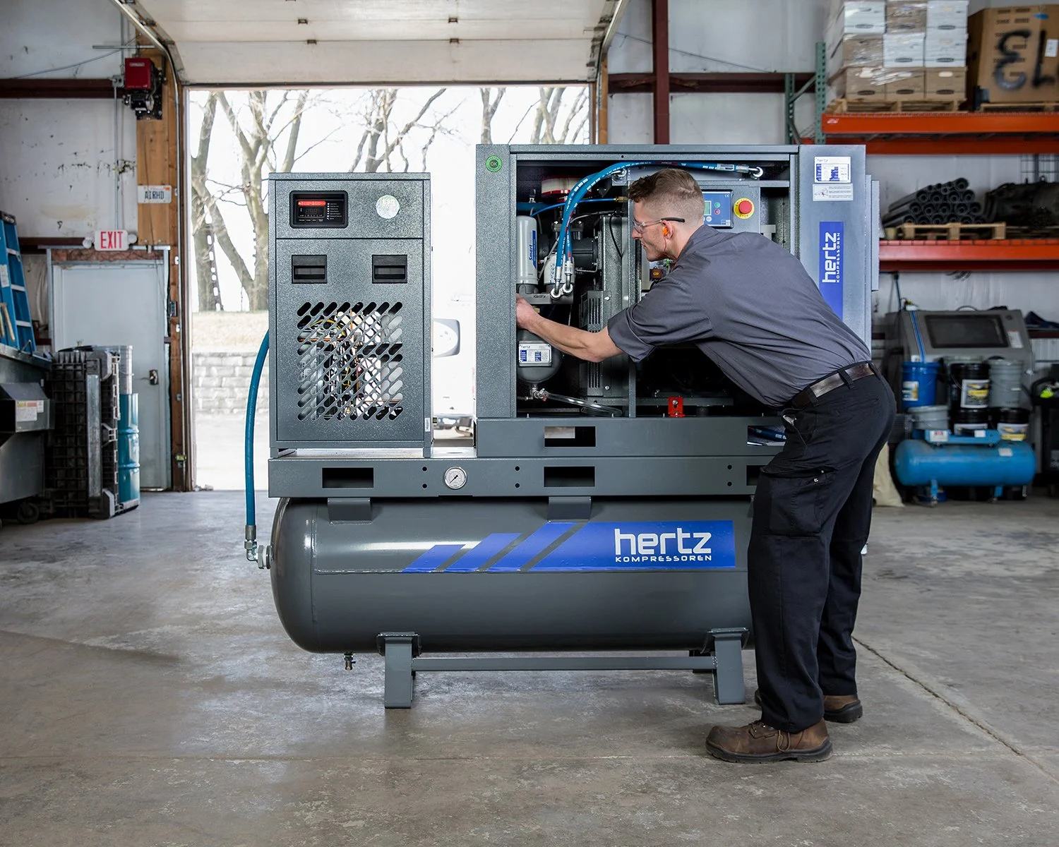 Industrial Factory Photography of a Technician Working on Industrial Machine in Warehouse Facility