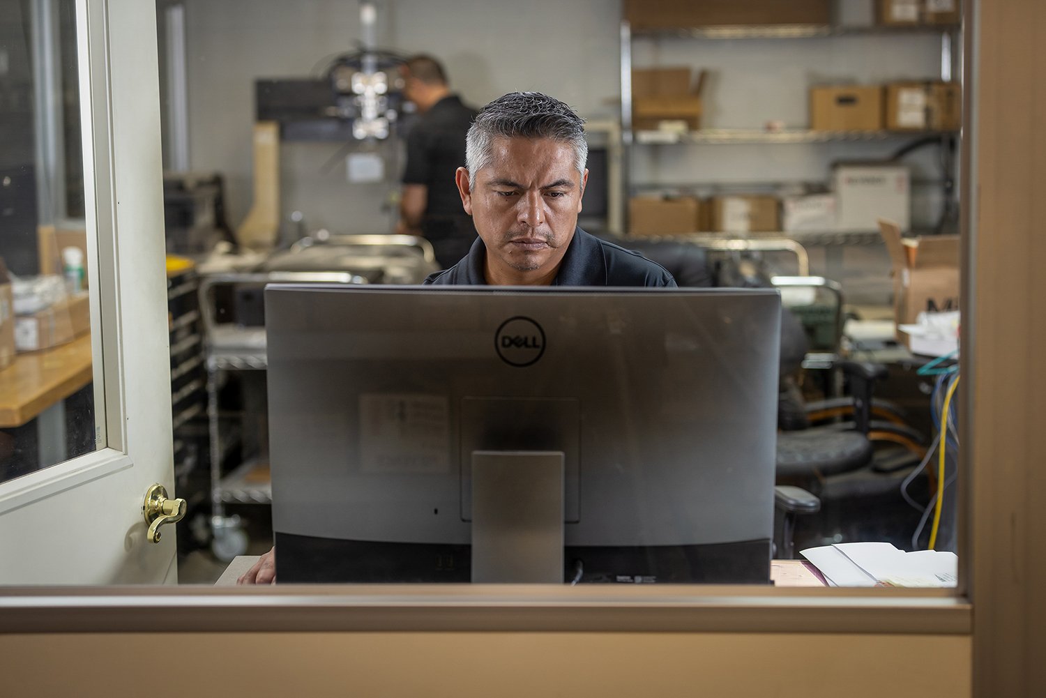 Chicago Industrial Photography of a Man Working on Computer in Industrial Office Setting