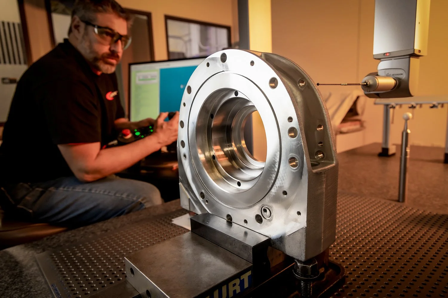 Industrial Factory Photography of A Manufacturing Technician Operates a Coordinate Measuring Machine Probe to Inspect a Machined Steel Part