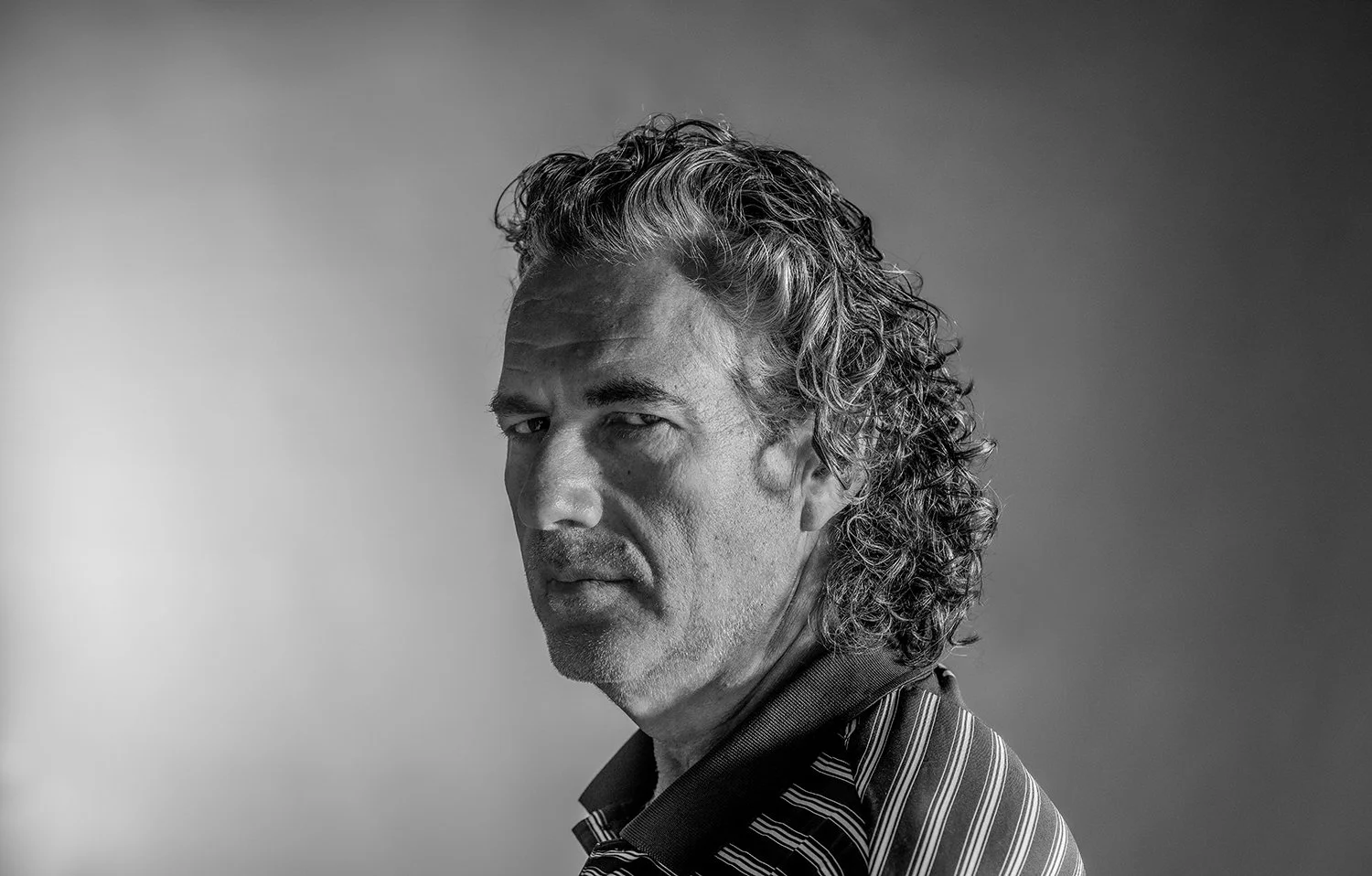 Black and White Studio Portrait of Man with Wavy Hair