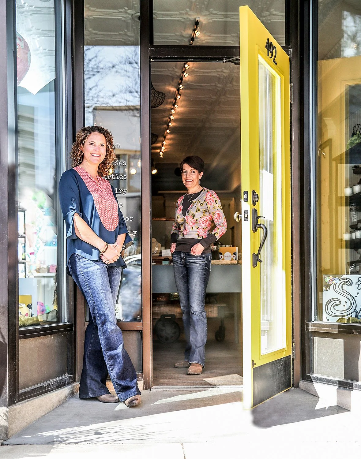 Corporate Branding Portrait of Two Smiling Female Business Owners Standing in the Doorway of their Boutique Retail Shop