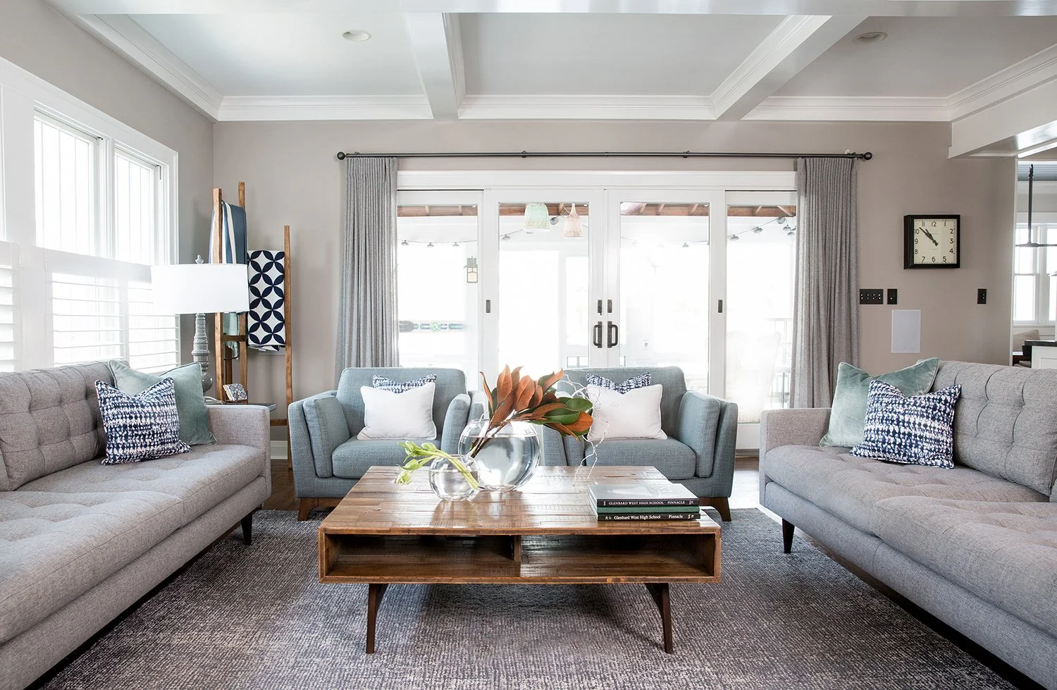 Chicago Interior Photography of a Bright Living Room Interior with Gray Tufted Sofas, Blue Armchairs, and a Wooden Coffee Table