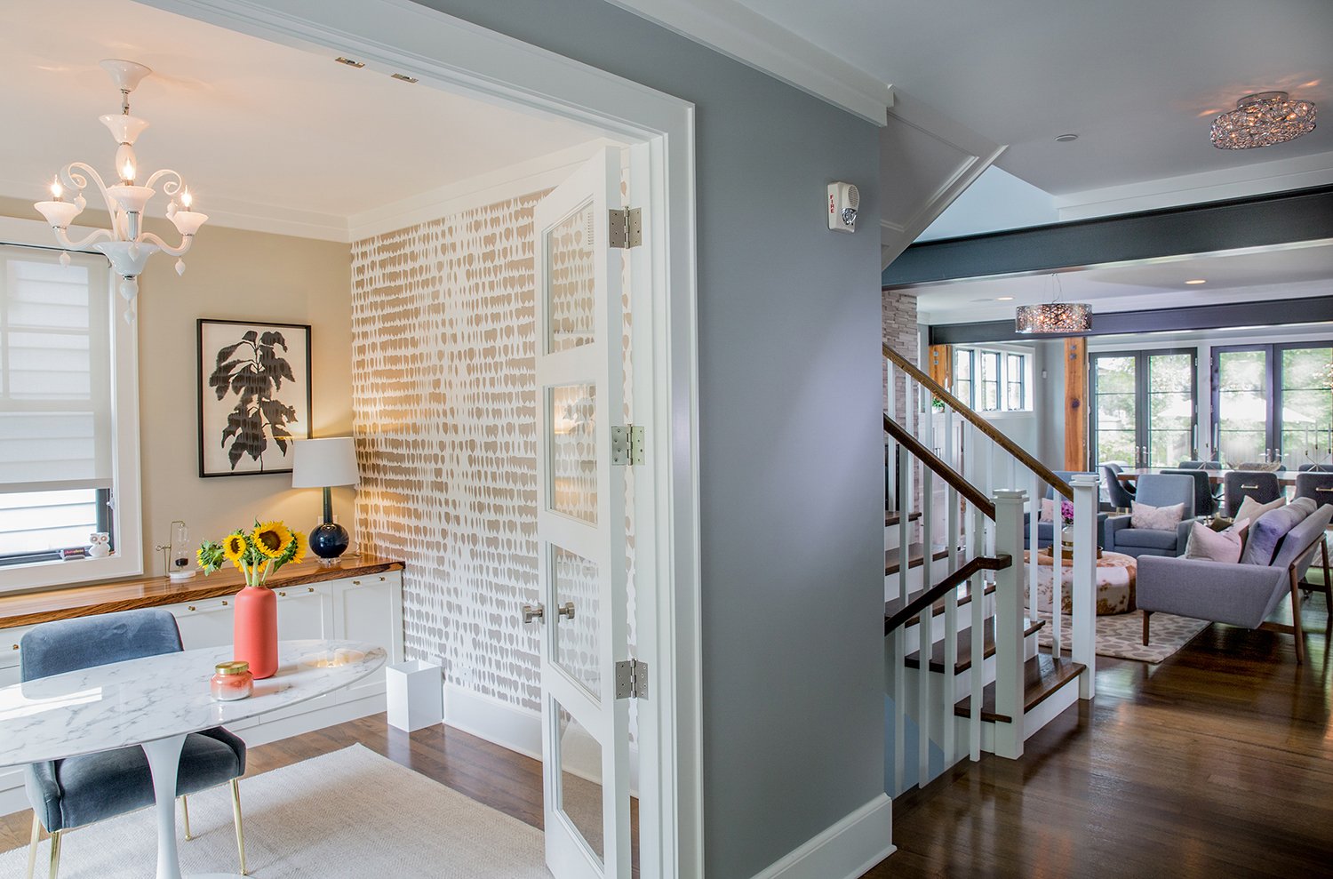 Environmental Interior Photography Showcasing a Layered View of a Modern Home Office, Staircase, and Living Room