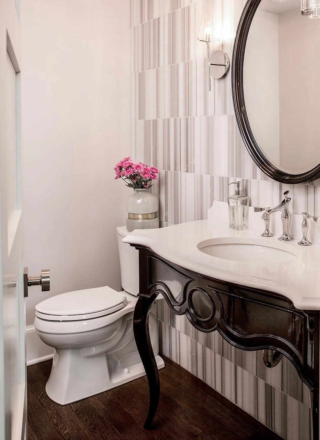 Beautiful Powder Room Featuring a Black Ornate Vanity, White Marble Sink, and Textured Accent Wall Tile