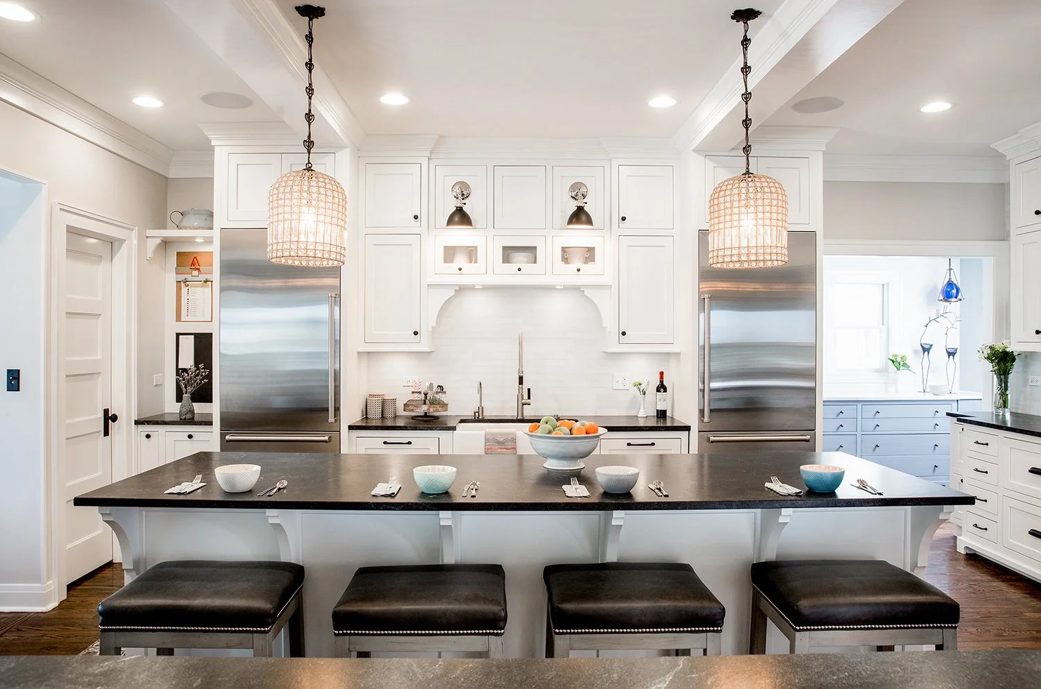 Symmetrical Interior Photography of a Custom Transitional Kitchen Featuring Dual Stainless Steel Refrigerators and Built-In Cabinetry