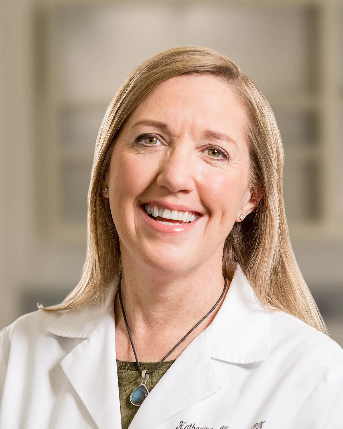 Close Up Portrait of Female Doctor Smiling and Laughing in White Lab Coat