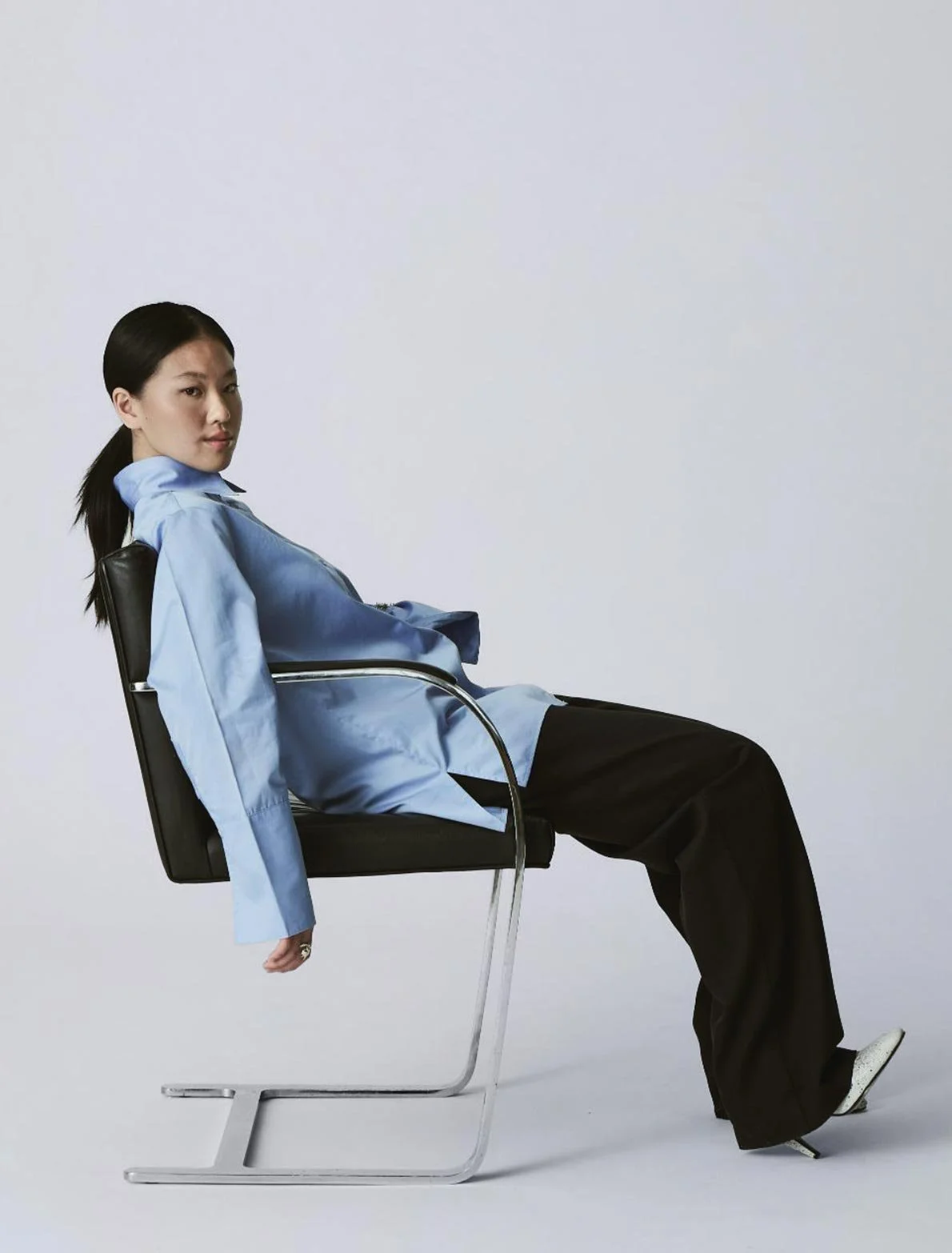 Kreativquartier Graz Studio Shot with designer chair and woman smiling