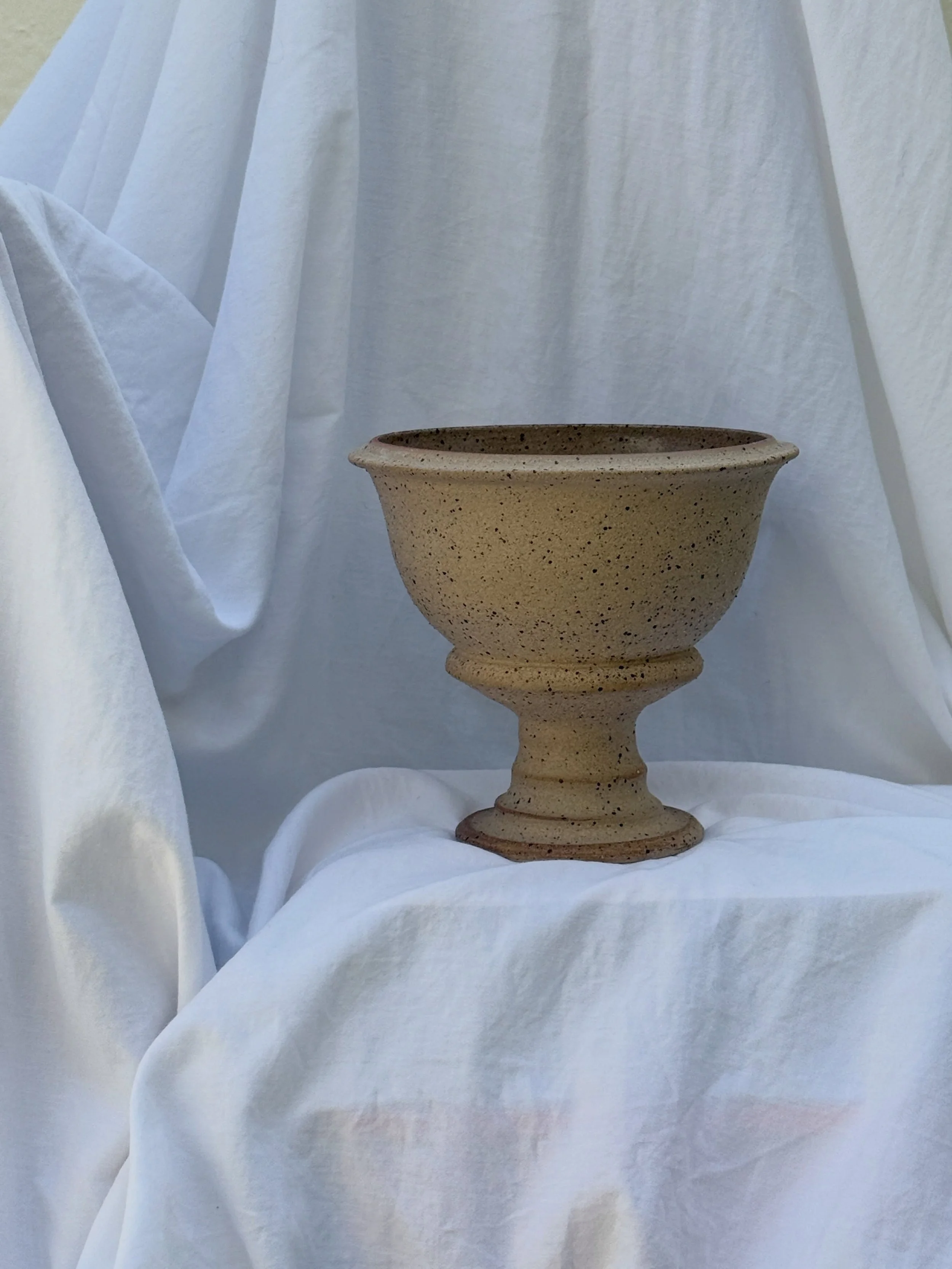 〰️ Adelphi Bowl 〰️
This pillar-bowl shape is a perfect catch-all for an entryway, or works wonderfully with a &lsquo;flower frog&rsquo; for floral arrangements. Made in a toasted brown speckled clay with a lovely natural texture, it has a raw exterio