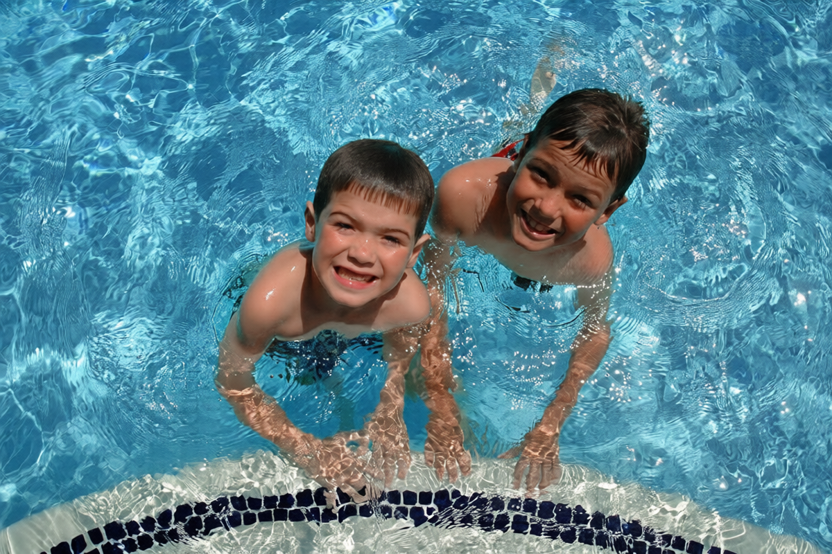 Two-boys-swimming-smiling-at-camera
