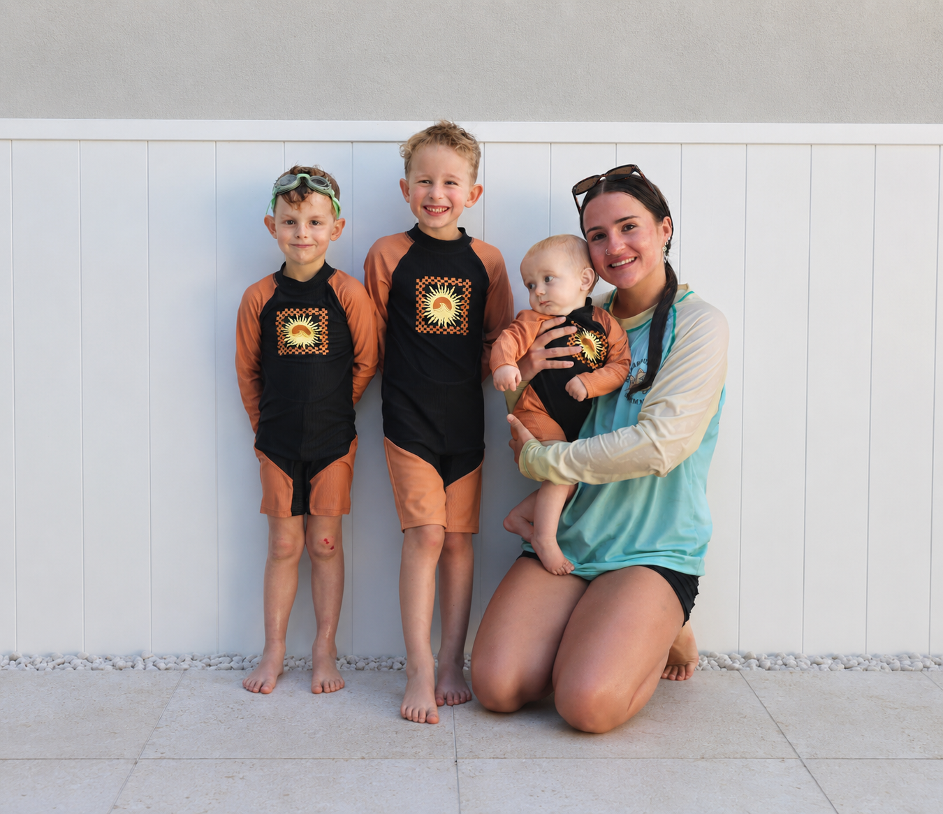 three-kids-and-a-swim-instructor-smiling-for-a-photo
