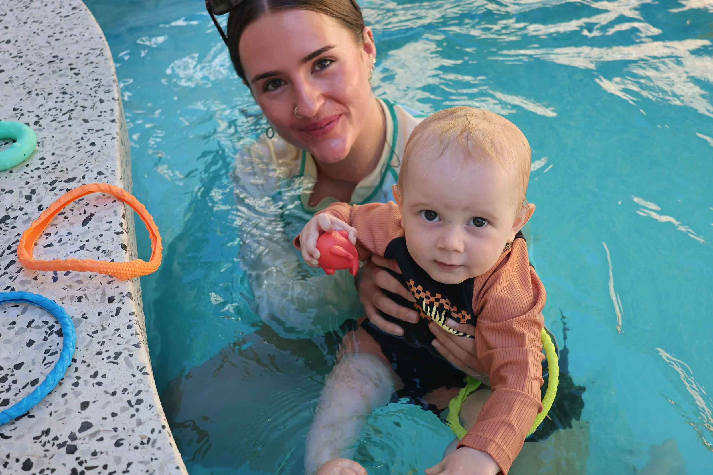baby-swimming-smiling-at-the-camera