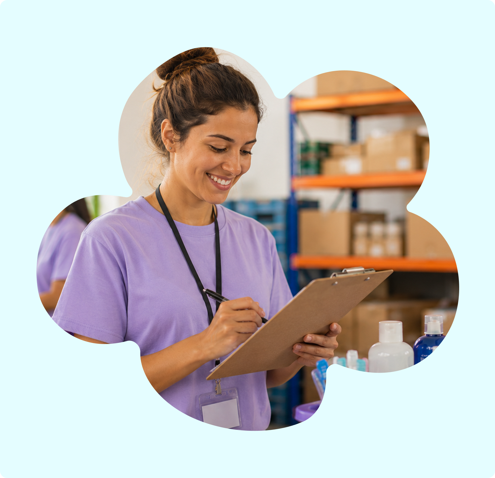 A smiling woman in scrubs holding a clipboard and writing, in a storage room with shelves and bottles.