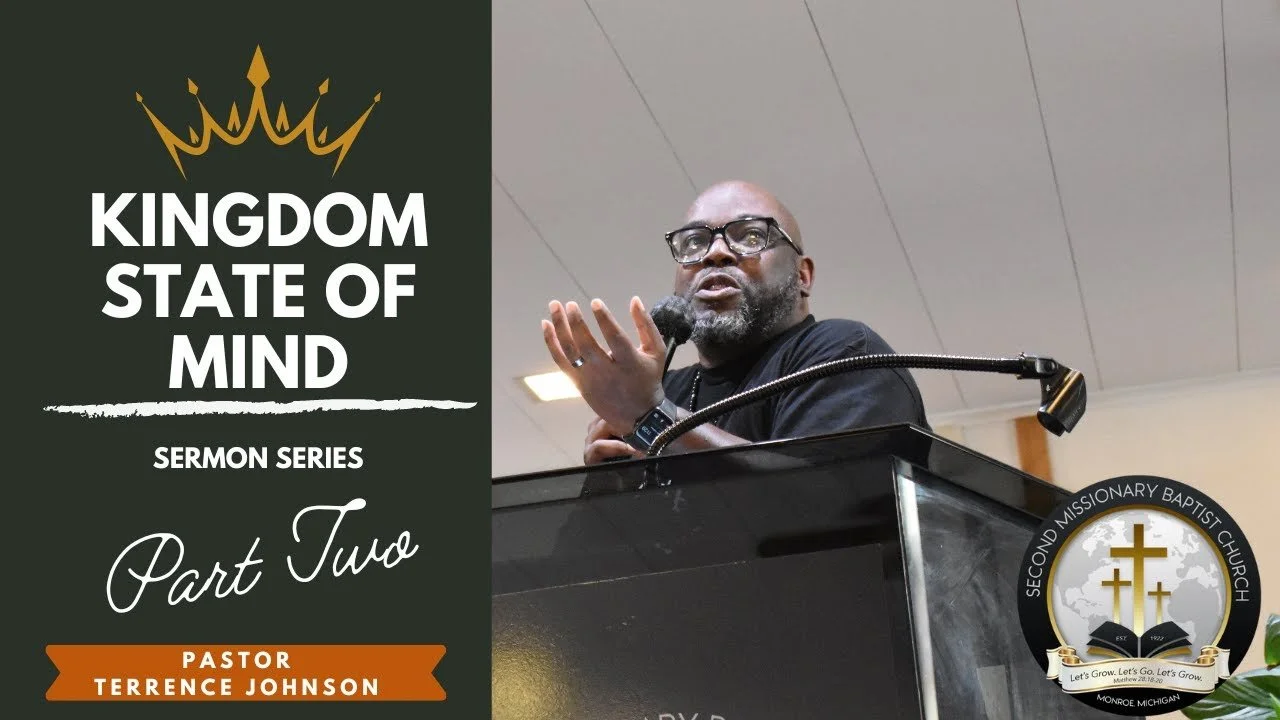 A speaker at a podium gesturing with his right hand during a sermon series titled 'Kingdom State of Mind,' Part Two, led by Pastor Terrence Johnson at Second Missionary Baptist Church in Monroe, Michigan.