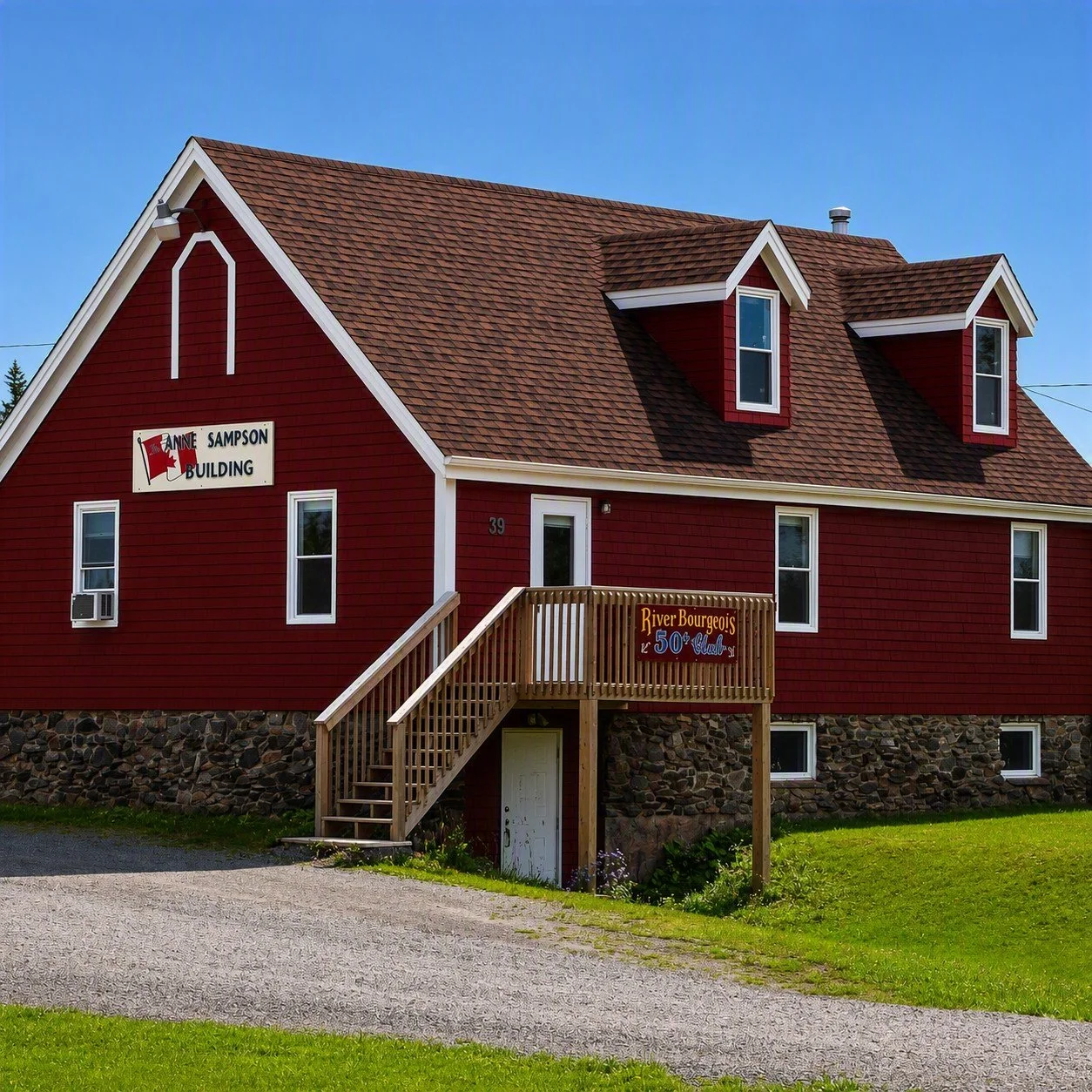 River Bourgeois seniors club, a red barn-style building with a wooden staircase