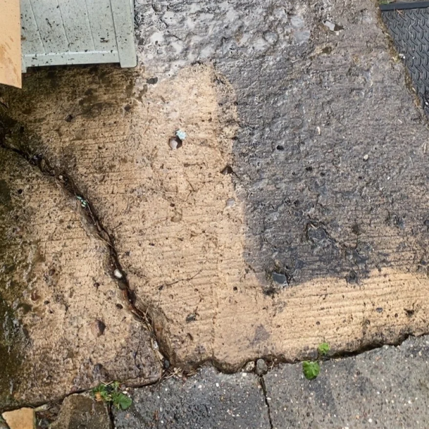 A side by side comparison of a pressure washed patio