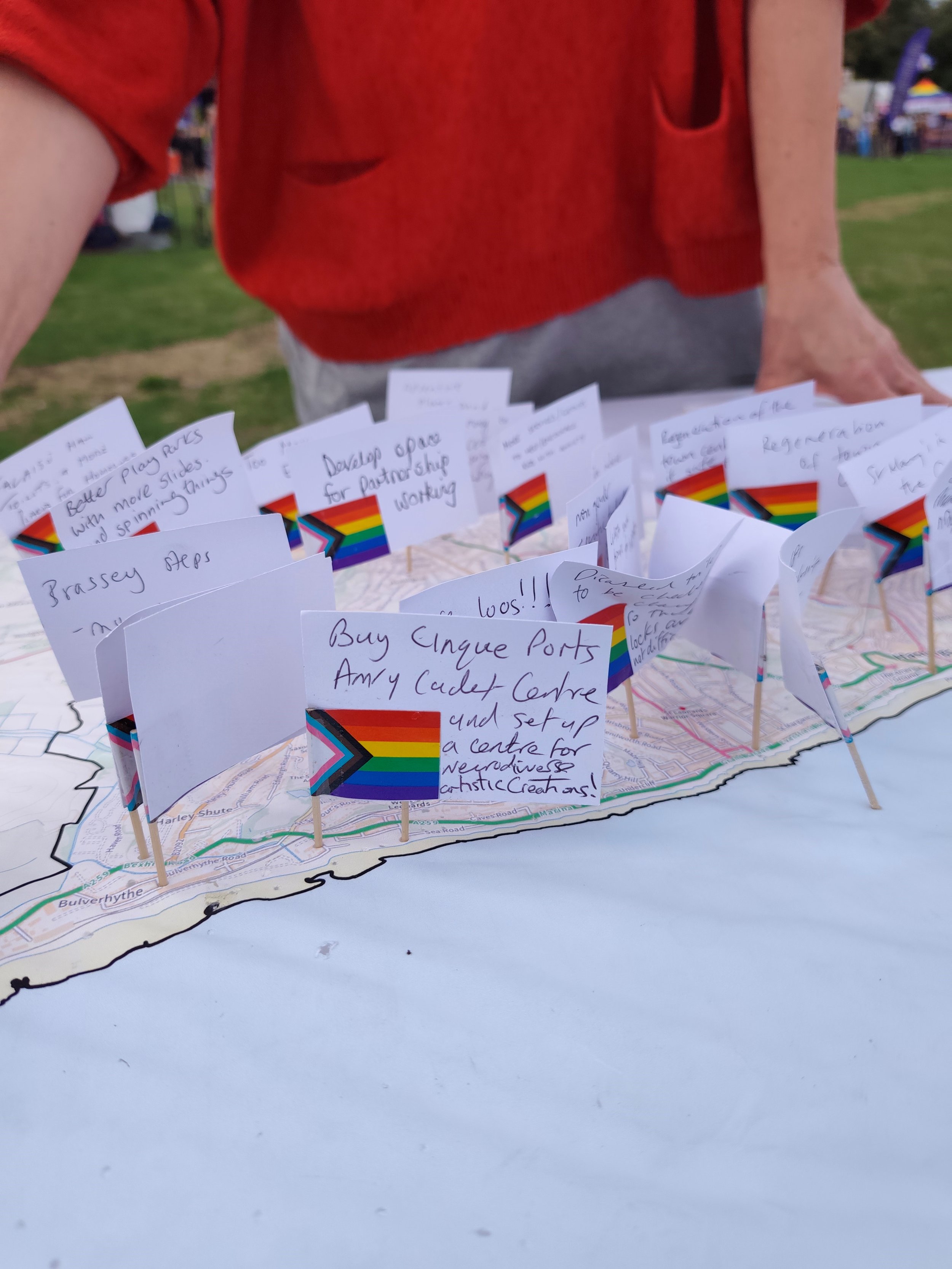 Small paper flags with handwritten ideas to improve Hastings.