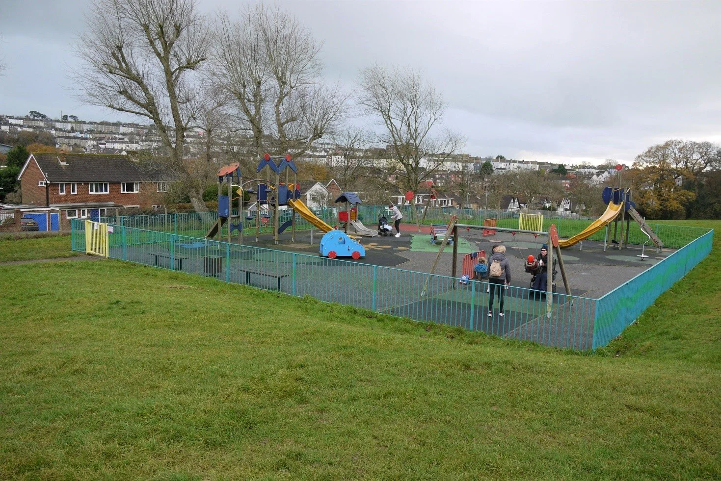 Children's playground surrounded by grass and looking over Hastings.