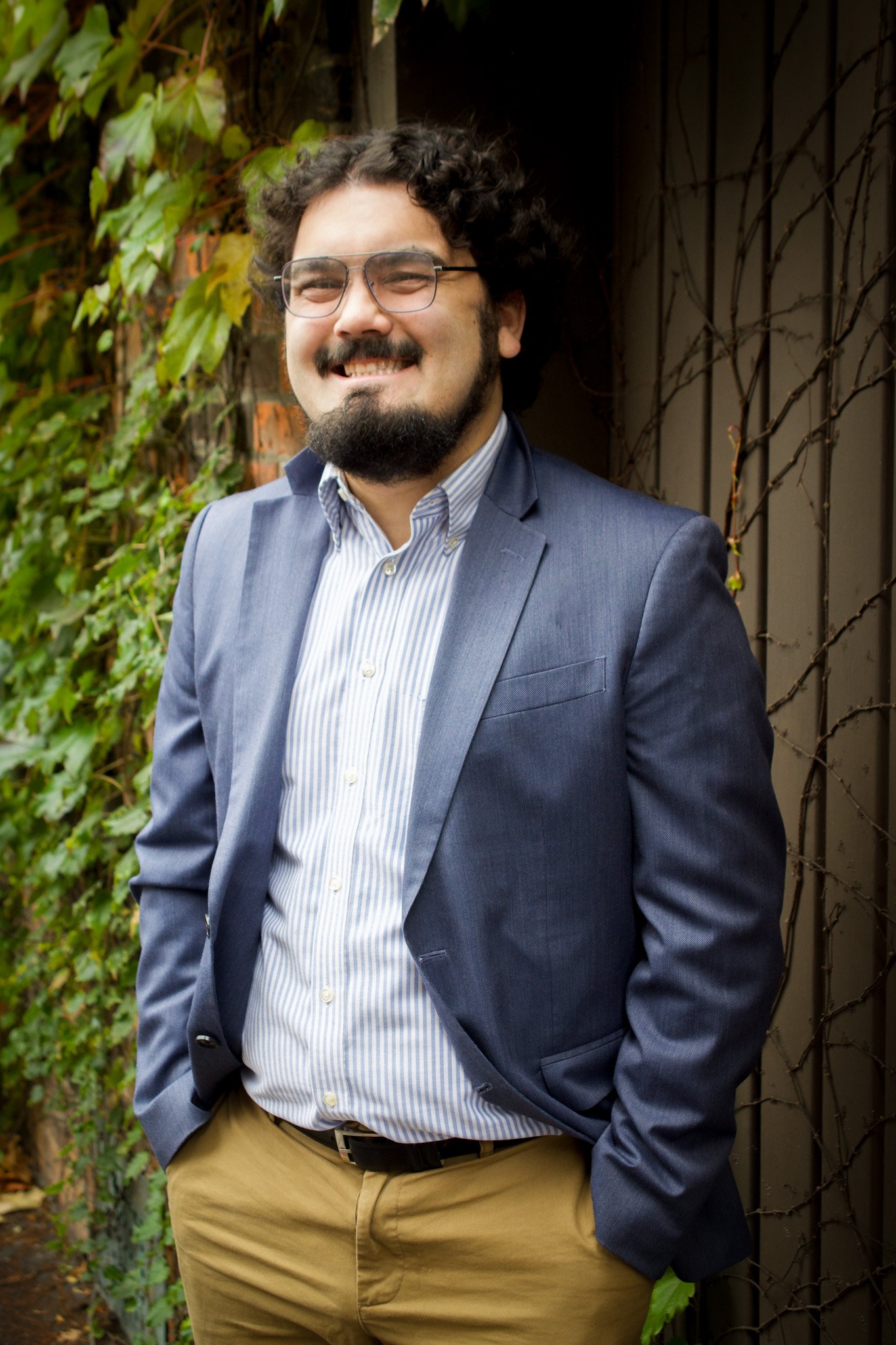 Man with beard smiling in a suit