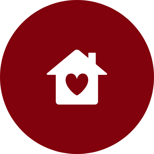 White house icon with a heart in the center on a red circular background.