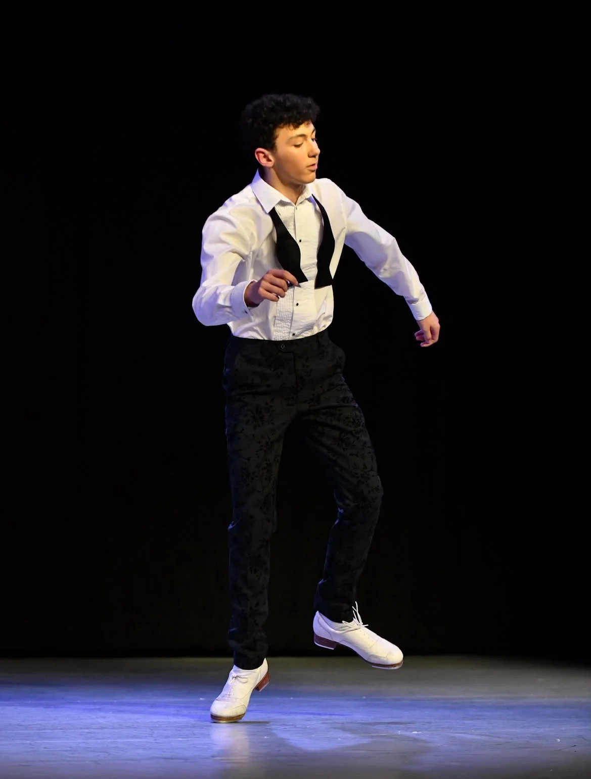 A young male tap dancer
