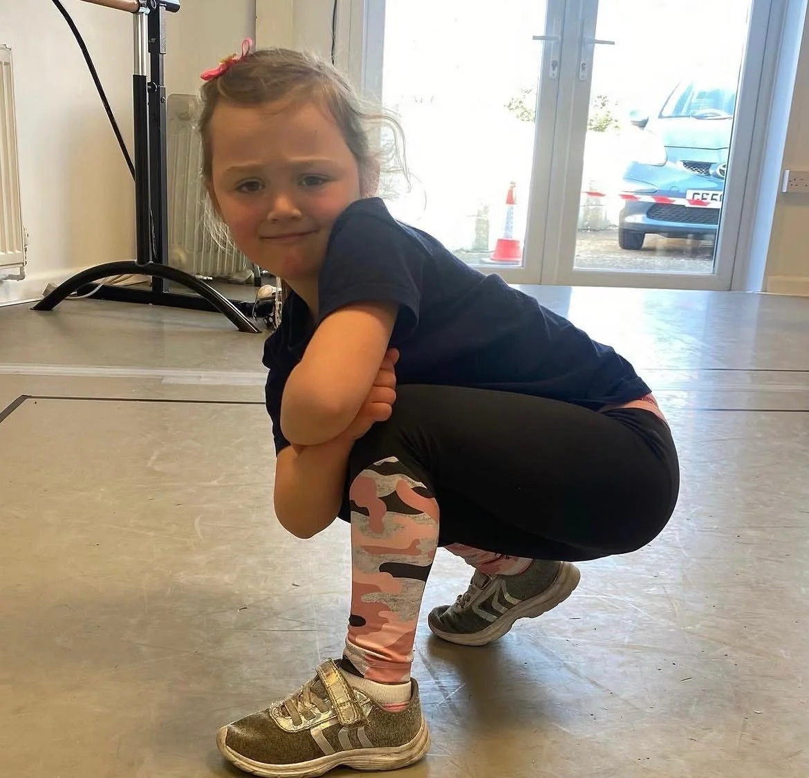 A young girl in junior commercial jazz dance class