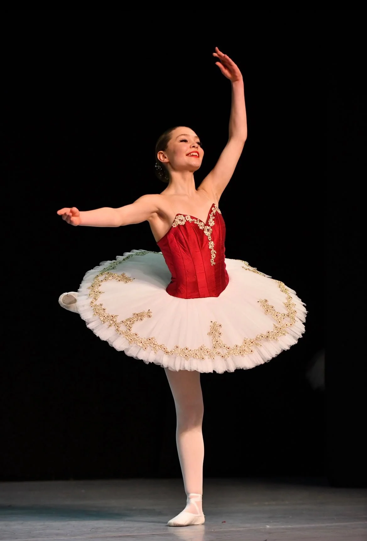 A ballerina in a red and white tutu