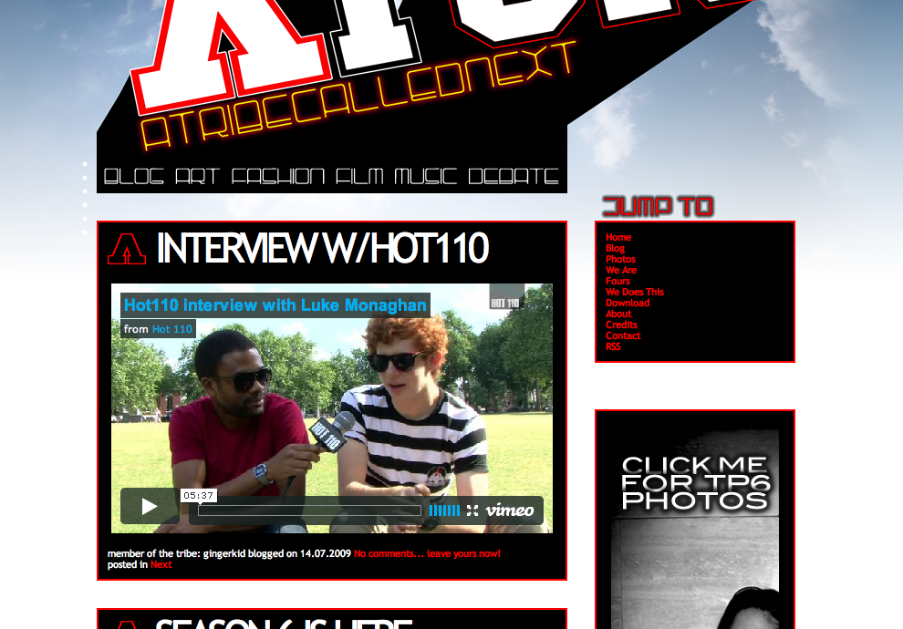 Screenshot of a website with an interview video featuring two young men, one in red shirt and sunglasses, and the other in a striped shirt and sunglasses, sitting on a park bench.