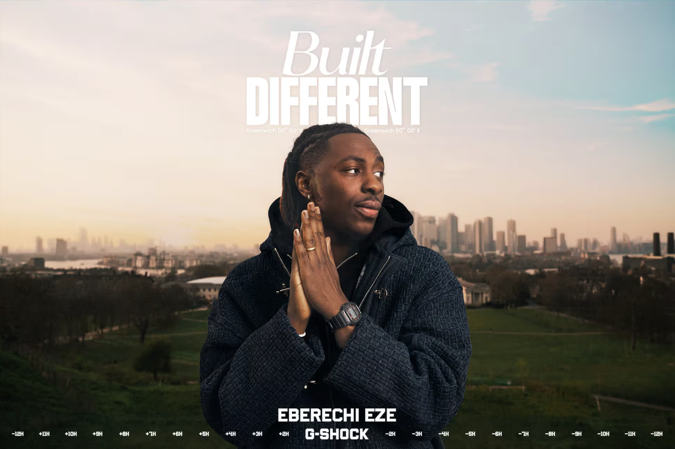 A man with dreadlocks and a black jacket standing outdoors with a city skyline in the background during sunset or sunrise. The image includes overlaid text reading 'Built Different' and at the bottom, 'EBERECHIZE' and 'G-SHOCK,' with time zone indicators along the bottom edge.