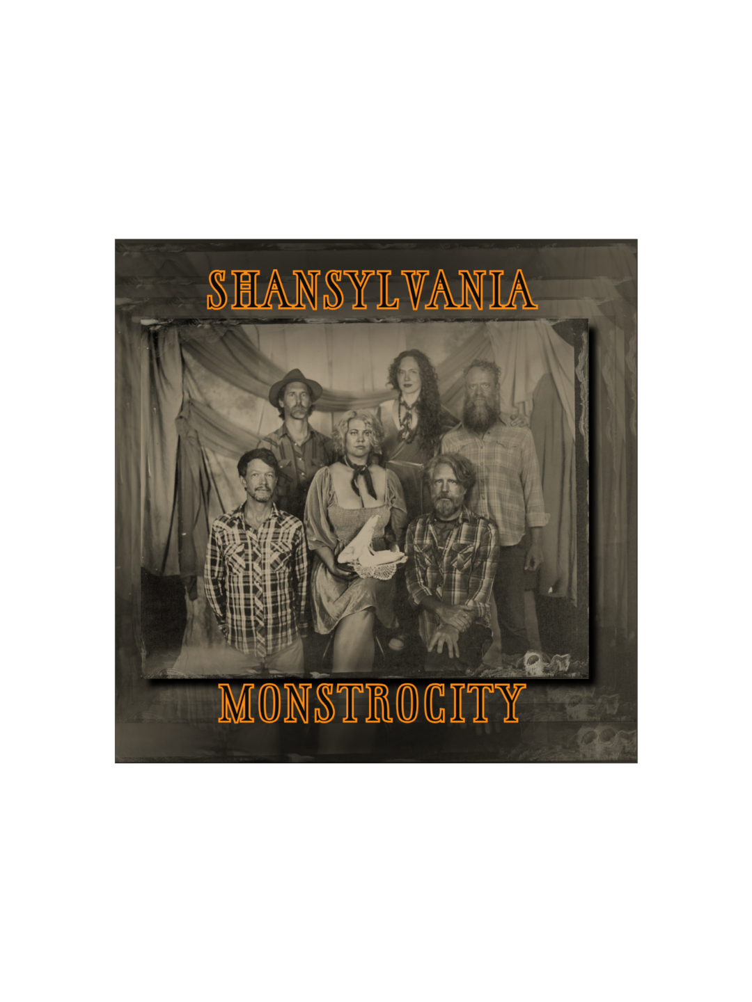 Album cover for Shansylvania Monstrocity. A tintype photograph of six people, three men and three women, dressed in vintage and casual clothing, seated and standing in front of a draped curtain backdrop.