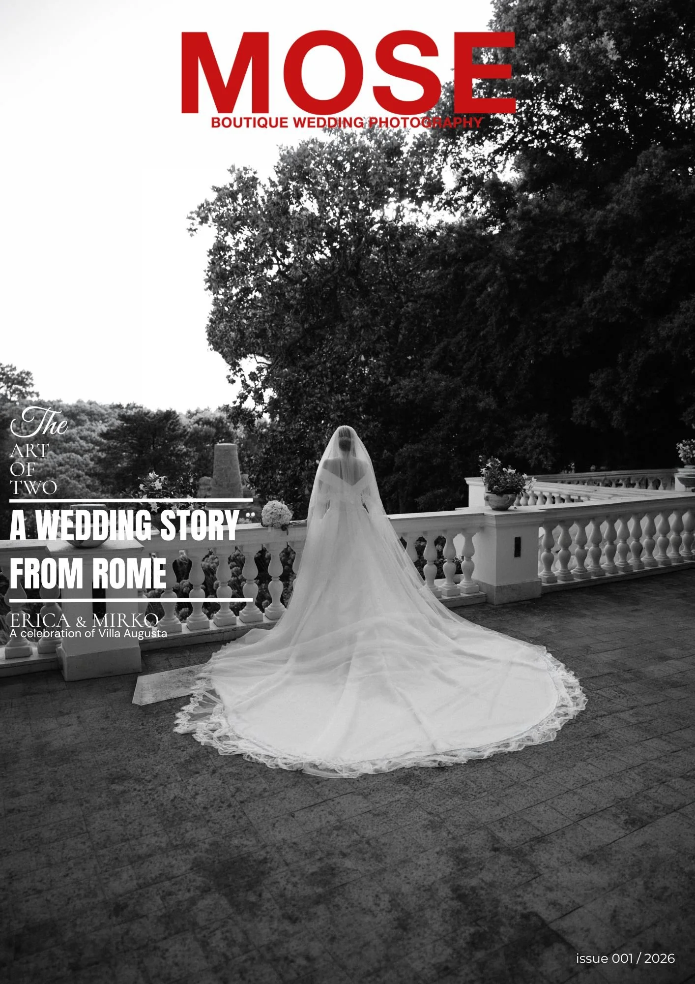 Black and white photo of a bride in a long wedding gown with a veil standing on a balcony. The balcony has a decorative white railing, and there are potted plants and flowers. Behind her are large trees and an overcast sky.