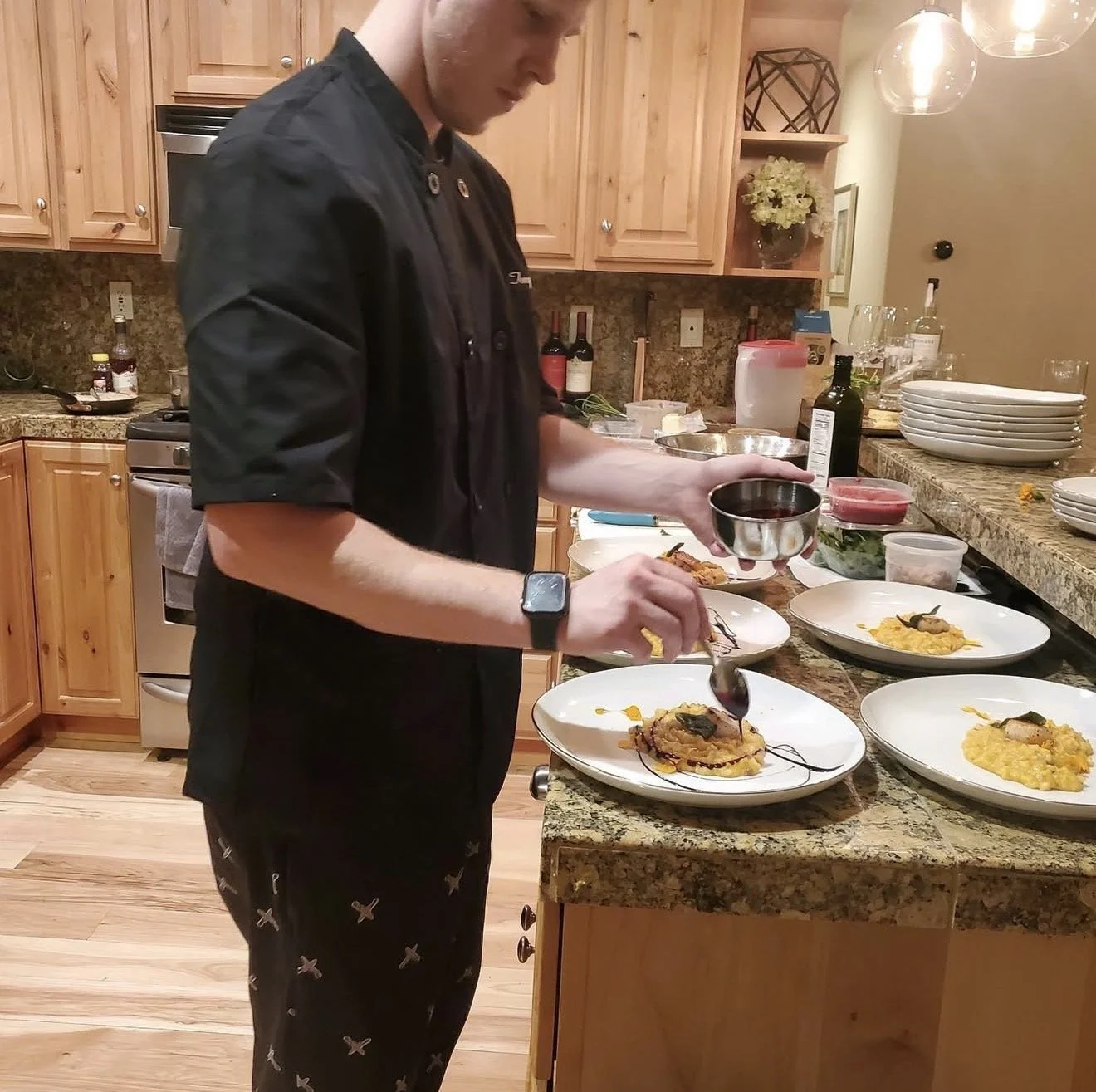 Chef Anthony Schafer preparing a private dining experience for a multi-course meal..