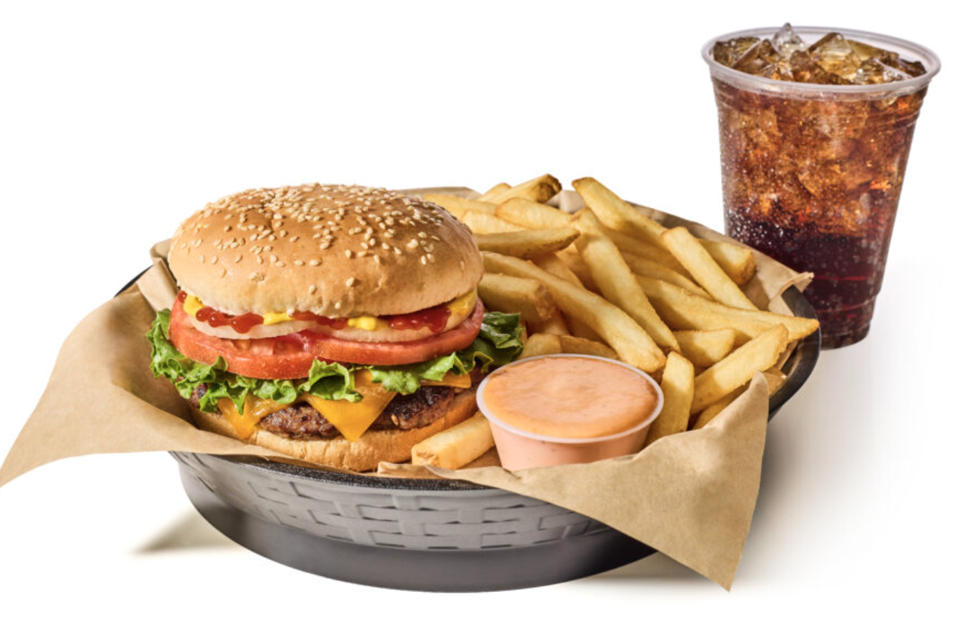 Burger with lettuce, tomato, cheese, and condiments, served with French fries, a side of dipping sauce, a cup of soft drink, all arranged on a black tray lined with paper.