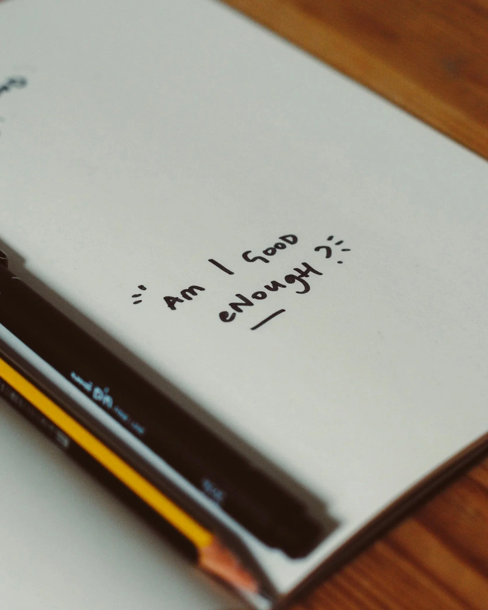 Close-up of a whiteboard with handwritten text in black ink that reads: 'I ({) Am I God?' with a small sun-like drawing.