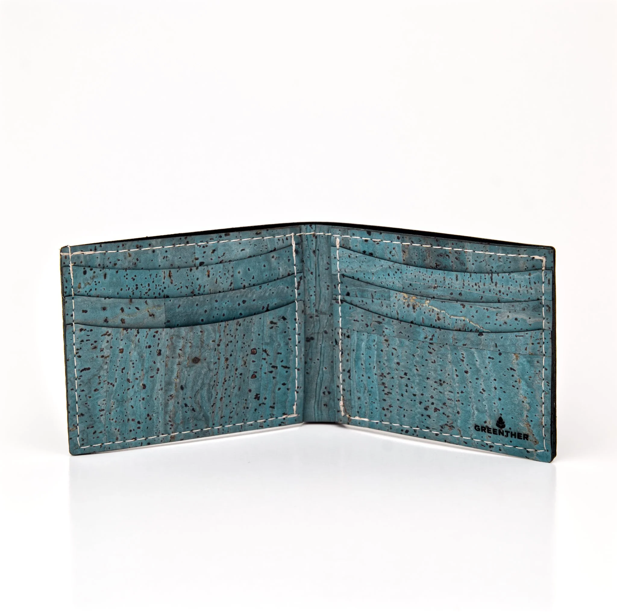 A blue, weathered, quilted fabric wallet with white string stitches and a small logo that reads 'Greenther' at the bottom right corner.