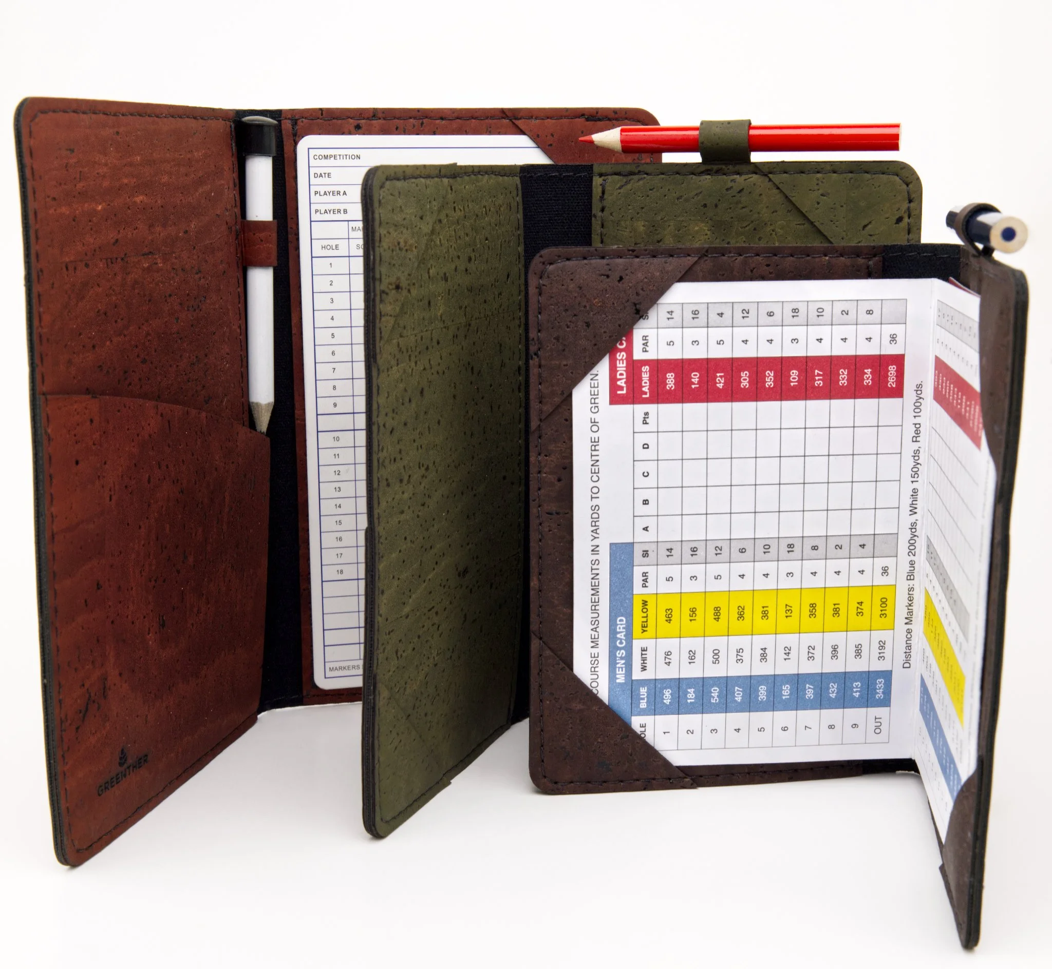 Close-up of a golf scorecard holder with scorecards, a white pen, a red pen, and a golf tee, against a white background.