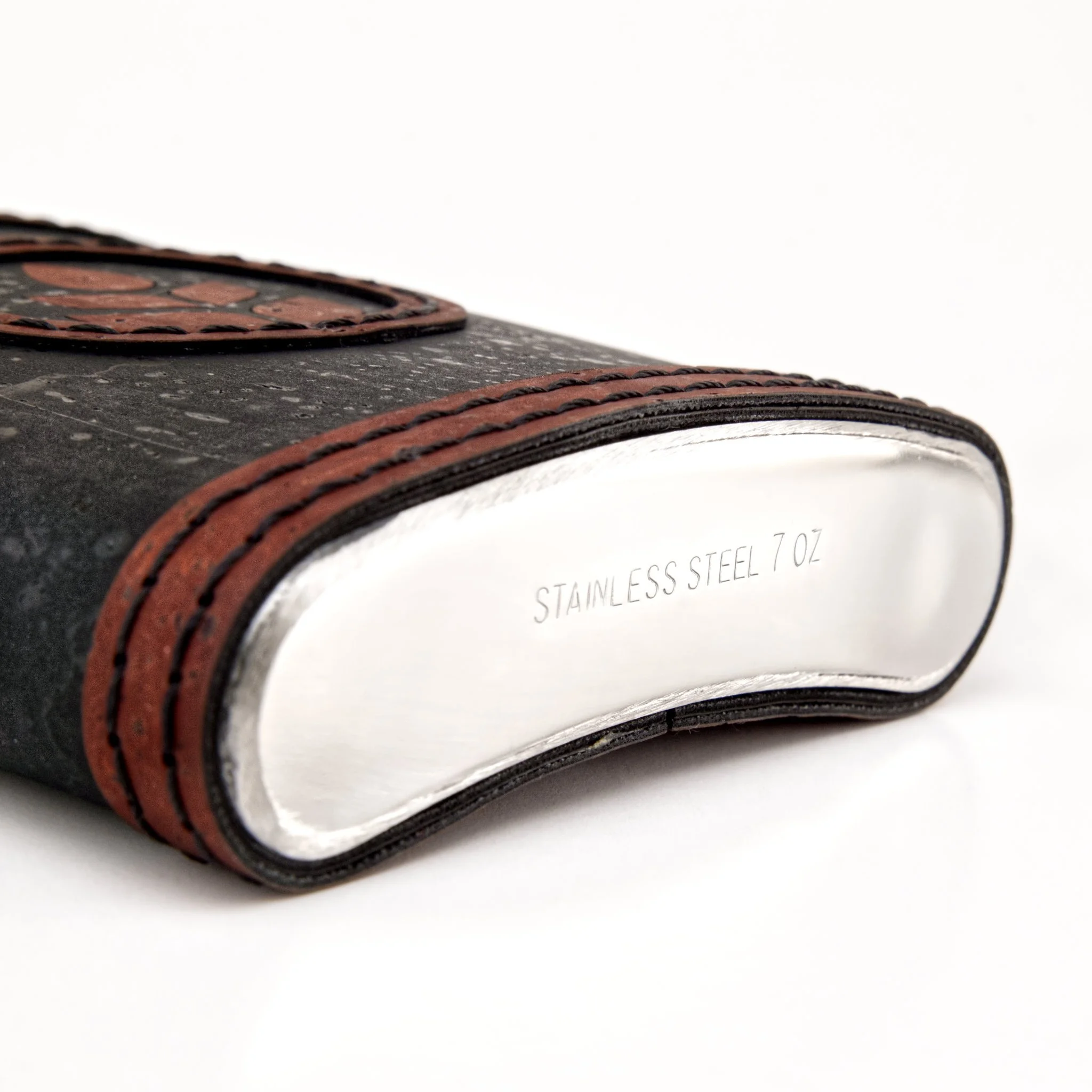 Close-up of a rolled-up leather wallet with multiple card slots, showing textured black leather and brown stitching, against a white background.