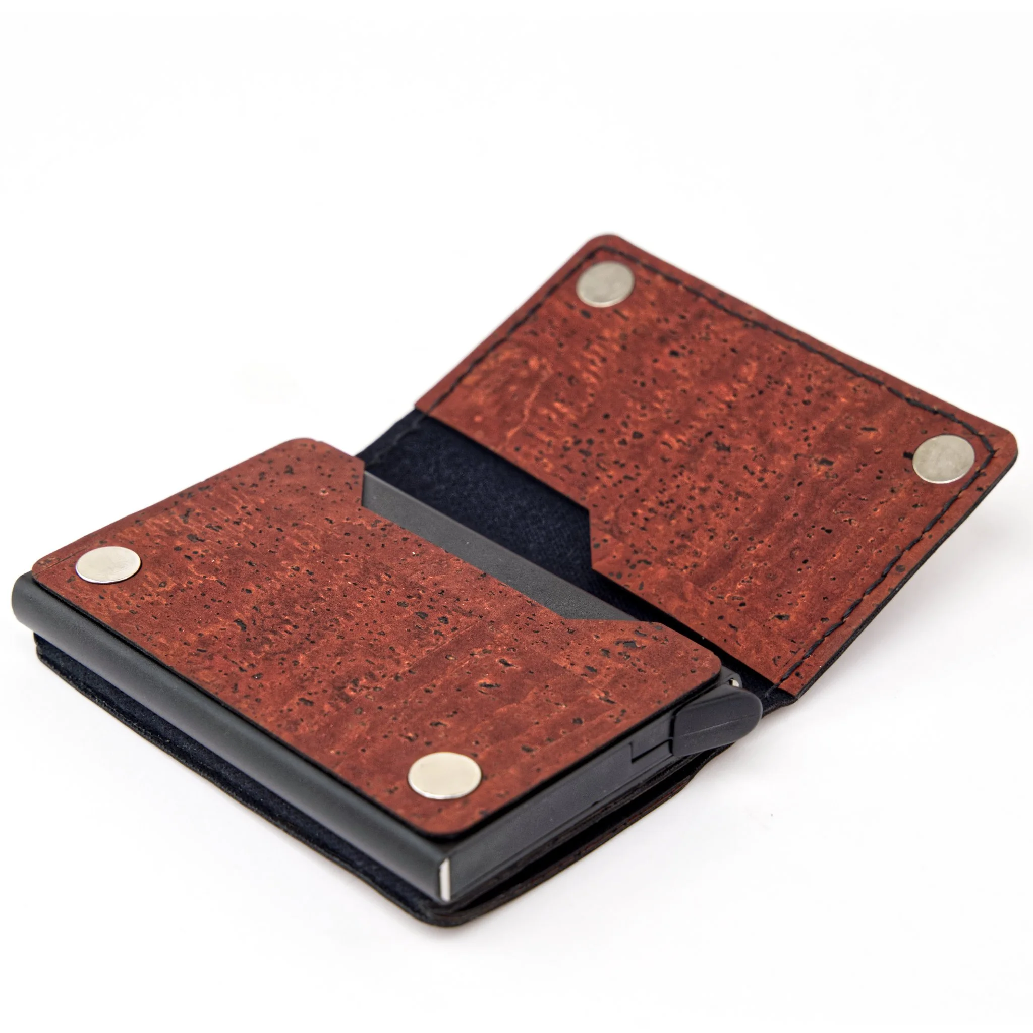Close-up of a red textured leather wallet with silver snap buttons on a white surface.