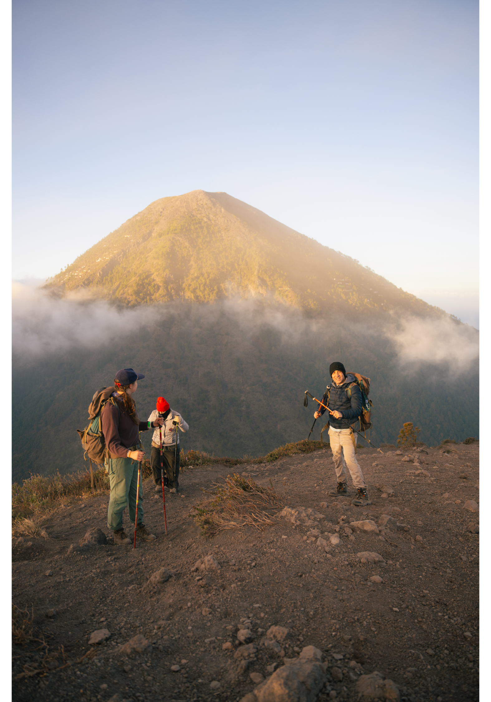 Photograph of three hikers standing on Volcan de Fuego in Guatemala.