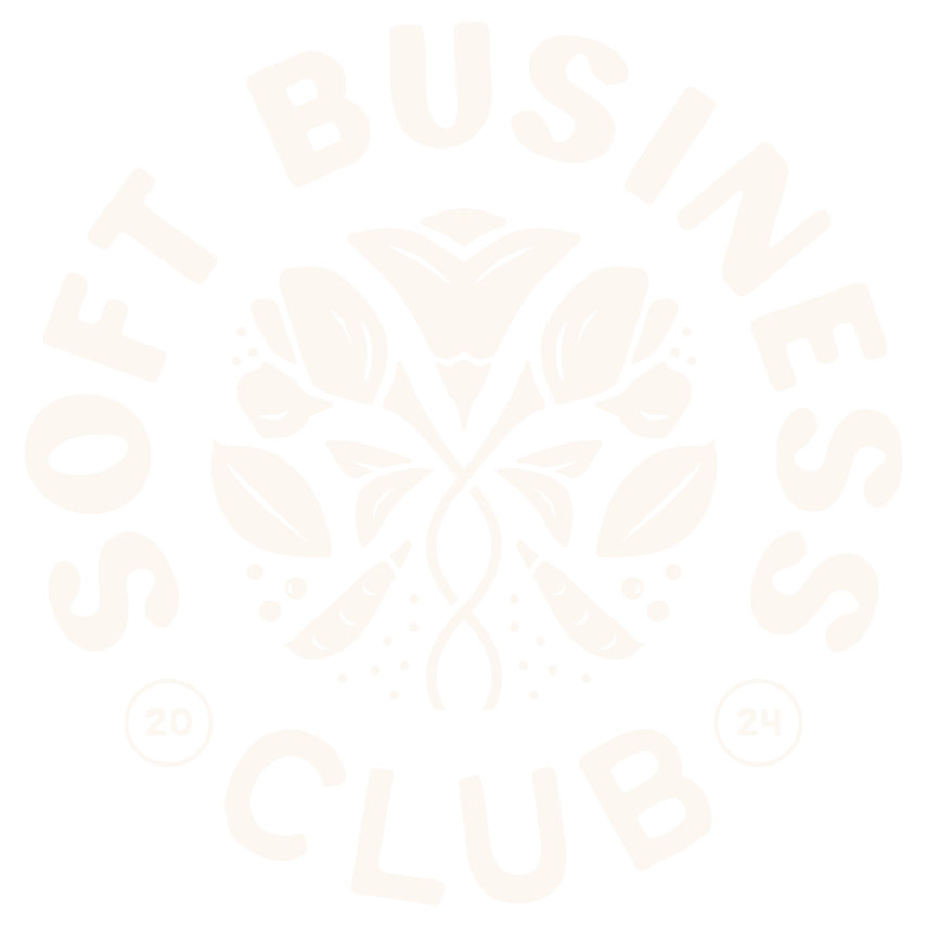 A circle logo badge with a white floral design and the words "Soft Business Club", with the year "2024" broken into two circles on either side.