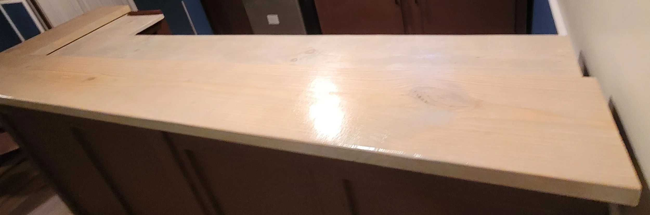 A wooden countertop with a light, natural finish in a kitchen setting.