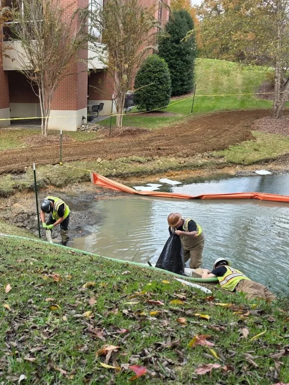 OES field crew performing environmental cleanup and remediation near a waterway.